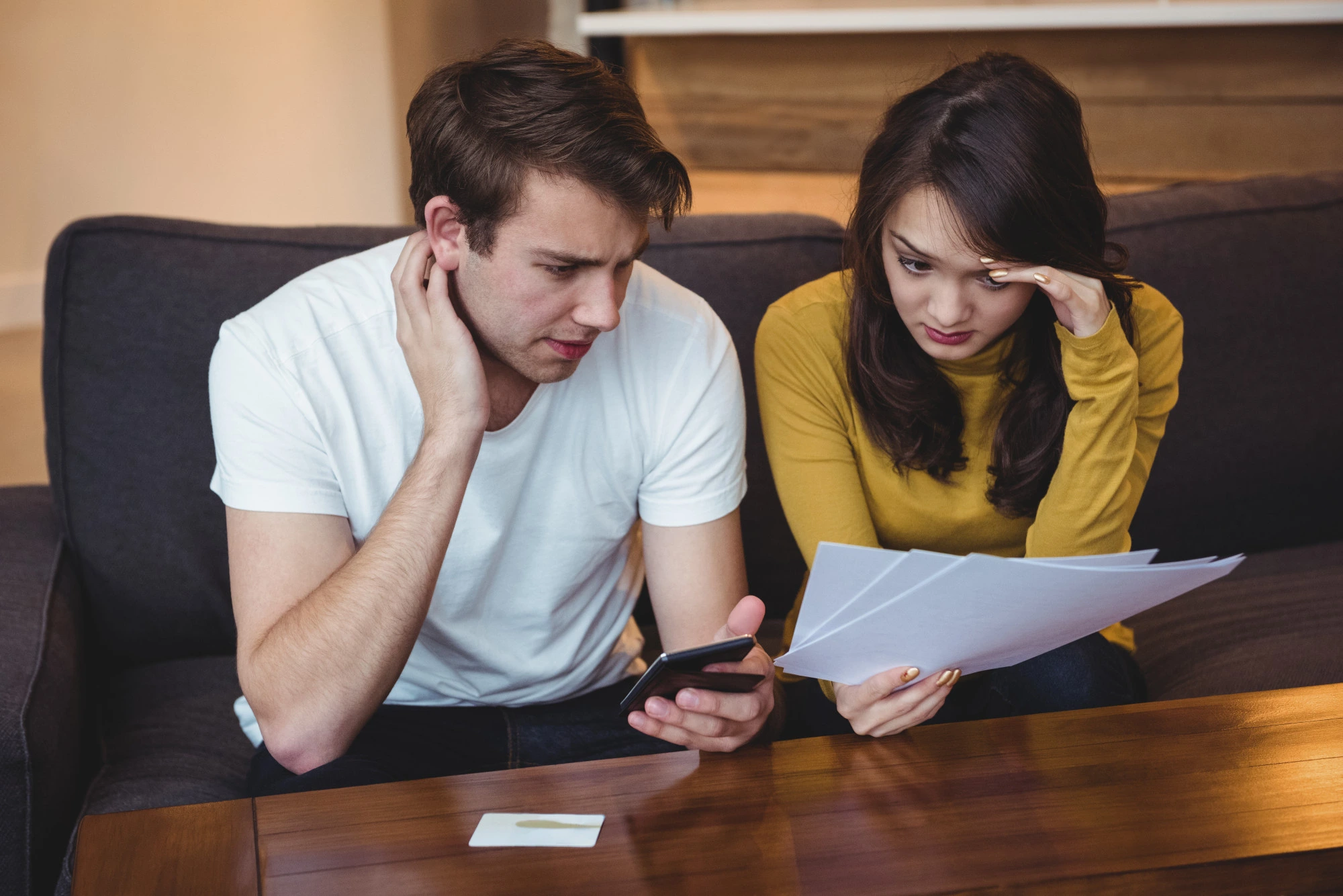 Stock image of two person having headache thinking of solution